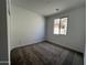 Cozy bedroom featuring carpet flooring and a bright window at 17547 W Lupine Ave, Goodyear, AZ 85338