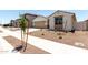 Charming single-story home featuring desert landscaping, a two-car garage, and a covered entryway at 17547 W Lupine Ave, Goodyear, AZ 85338