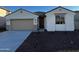 Charming single-story home with a two-car garage and desert landscaping in front at 17547 W Lupine Ave, Goodyear, AZ 85338