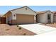 Charming single-story home featuring desert landscaping, a two-car garage, and a covered entryway at 17547 W Lupine Ave, Goodyear, AZ 85338