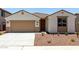 Charming single-story home featuring desert landscaping, a two-car garage, and a covered entryway at 17547 W Lupine Ave, Goodyear, AZ 85338