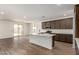Open-concept kitchen with a large island, stainless steel appliances, and sliding doors to the backyard at 17547 W Lupine Ave, Goodyear, AZ 85338