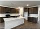 Modern kitchen featuring stainless steel appliances, white countertops, and dark cabinets at 17547 W Lupine Ave, Goodyear, AZ 85338