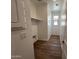 Bright laundry room with wood-look tile flooring and shelving at 17547 W Lupine Ave, Goodyear, AZ 85338