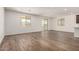 Spacious living room with wood-style tile flooring, recessed lighting, and large windows for natural light at 17547 W Lupine Ave, Goodyear, AZ 85338