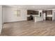 Open-concept kitchen and living room with tile floors and modern dark cabinetry at 17547 W Lupine Ave, Goodyear, AZ 85338