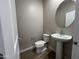 Half bathroom with toilet and pedestal sink at 17553 W Lupine Ave, Goodyear, AZ 85338