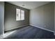 Neutral bedroom with carpeted floor, window bringing in natural light, and fresh paint at 17553 W Lupine Ave, Goodyear, AZ 85338