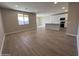 Open-concept living room and kitchen area with abundant natural light and stylish flooring at 17553 W Lupine Ave, Goodyear, AZ 85338