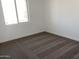 Bedroom featuring neutral carpet, white walls, and a bright window at 18035 W Vogel Ave, Goodyear, AZ 85338