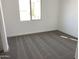 Bedroom featuring neutral carpet, baseboards and a window at 18035 W Vogel Ave, Goodyear, AZ 85338