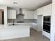 Modern kitchen with stainless steel appliances, quartz countertops, and center island with sink at 18035 W Vogel Ave, Goodyear, AZ 85338