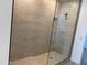 New shower featuring decorative tile design, glass enclosure, and modern fixtures for a spa-like experience at 18035 W Vogel Ave, Goodyear, AZ 85338