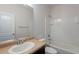 Standard bathroom with neutral-toned counter and sink, combined tub and shower, and a white wall at 1940 N 78Th Gln, Phoenix, AZ 85035