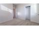 Bedroom with carpet, large closet, and two doors; bright, neutral color, and simple at 1940 N 78Th Gln, Phoenix, AZ 85035