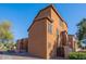 Exterior angle of two-story townhome building with brown stucco, a gate, and minimal landscaping at 1940 N 78Th Gln, Phoenix, AZ 85035