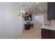 Spacious kitchen with dark cabinets, stainless steel appliances, and bright recessed lighting at 1940 N 78Th Gln, Phoenix, AZ 85035