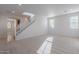 Spacious living room with neutral carpet, staircase, recessed lighting, and light walls for a modern look at 1940 N 78Th Gln, Phoenix, AZ 85035