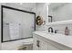 Well-lit bathroom featuring a modern vanity, decorative shelving, and a tiled shower with glass doors at 21784 E Puesta Del Sol --, Queen Creek, AZ 85142