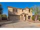 Charming two-story home featuring desert landscaping, stone accents, arched entryway, and a two car garage at 21784 E Puesta Del Sol --, Queen Creek, AZ 85142