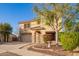 Inviting two-story home with a well-manicured front yard and charming stone accents on the facade at 21784 E Puesta Del Sol --, Queen Creek, AZ 85142