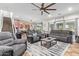 Open-concept living room featuring comfortable seating, a ceiling fan, and seamless flow to the kitchen at 21784 E Puesta Del Sol --, Queen Creek, AZ 85142