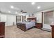 Bright main bedroom featuring a ceiling fan, plush carpeting, and dark wood furniture at 21784 E Puesta Del Sol --, Queen Creek, AZ 85142