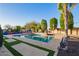 Inviting pool area surrounded by lush landscaping and stone accents, perfect for relaxation and recreation at 21784 E Puesta Del Sol --, Queen Creek, AZ 85142