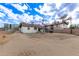 Backyard view of the house, revealing a spacious yard waiting for a personal landscape touch at 2256 W Ella St, Mesa, AZ 85201