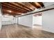 Spacious unfinished basement featuring concrete block walls and laminate floors at 2256 W Ella St, Mesa, AZ 85201