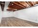 Unfinished basement featuring exposed beams, concrete block walls and laminate floors at 2256 W Ella St, Mesa, AZ 85201