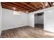 Bright basement featuring exposed beams, concrete block walls and laminate floors at 2256 W Ella St, Mesa, AZ 85201