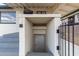 Stairs lead to a ground-level basement entry, secured by an iron gate and featuring neutral paint at 2256 W Ella St, Mesa, AZ 85201