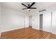 Bright bedroom featuring a closet, ceiling fan, and beautiful hardwood floors at 2256 W Ella St, Mesa, AZ 85201