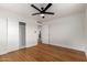 Bedroom boasting a large closet, a ceiling fan, and hardwood floors at 2256 W Ella St, Mesa, AZ 85201