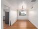 Dining room featuring wood floors, a chandelier, and natural light at 2256 W Ella St, Mesa, AZ 85201