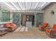 Bright and open back patio featuring travertine tile, a modern shade cover, seating, and sliding doors into the home at 2601 S Entwistle St, Gilbert, AZ 85295