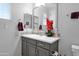 Bathroom features a modern sink with cabinetry and decorative tiling in neutral tones at 2601 S Entwistle St, Gilbert, AZ 85295