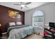 Cozy bedroom showcasing a ceiling fan and plenty of natural light from the windows at 2601 S Entwistle St, Gilbert, AZ 85295