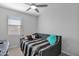 Neutral bedroom with a ceiling fan and comfortable daybed at 2601 S Entwistle St, Gilbert, AZ 85295