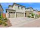 Well-kept two-story home with a three-car garage, manicured landscaping, and a spacious driveway under a blue sky at 2601 S Entwistle St, Gilbert, AZ 85295