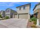 Well-maintained two-story home with a three-car garage, manicured landscaping, and a spacious driveway under a blue sky at 2601 S Entwistle St, Gilbert, AZ 85295