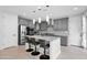 Contemporary kitchen with gray cabinets, granite countertops, a central island with seating, and modern pendant lighting at 2601 S Entwistle St, Gilbert, AZ 85295