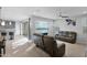 Spacious and naturally lit living room featuring gray walls, wood floors, and comfortable leather furniture at 2601 S Entwistle St, Gilbert, AZ 85295