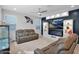 Bright and modern living room with cozy leather seating and an entertainment center with fireplace and custom shelving at 2601 S Entwistle St, Gilbert, AZ 85295