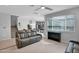 Cozy living room with plush seating, and neutral decor, leading to the kitchen and featuring a modern ceiling fan at 2601 S Entwistle St, Gilbert, AZ 85295