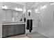 Main bathroom with double sinks, gray cabinets, a large mirror and a walk-in shower at 2601 S Entwistle St, Gilbert, AZ 85295