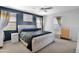 Main bedroom with dark accent wall, ceiling fan, and a king-size bed at 2601 S Entwistle St, Gilbert, AZ 85295