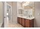 Bathroom featuring tile floors, vanity with granite counters and a decorative mirror at 3044 E Trigger Way, Gilbert, AZ 85297