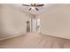 Neutral bedroom with a ceiling fan, carpeted floors, and adjoining closet and bathroom at 3044 E Trigger Way, Gilbert, AZ 85297